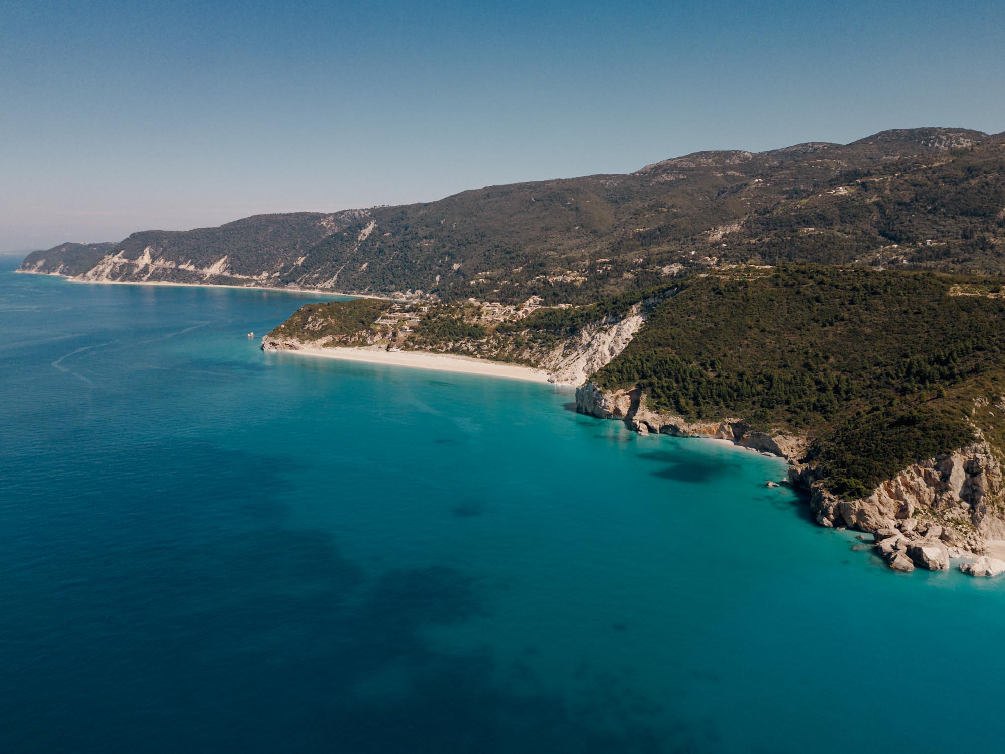 A photo of the coastline of the island of Lefkada. Lefkada is one of the best day trips from Paleros as it lies just half an hour away. It also is one of the best things to do in Paleros.